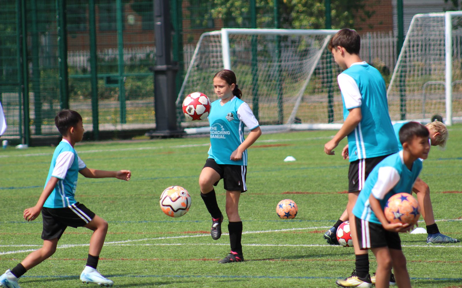 Young players practising ball control at a The Coaching Manual session